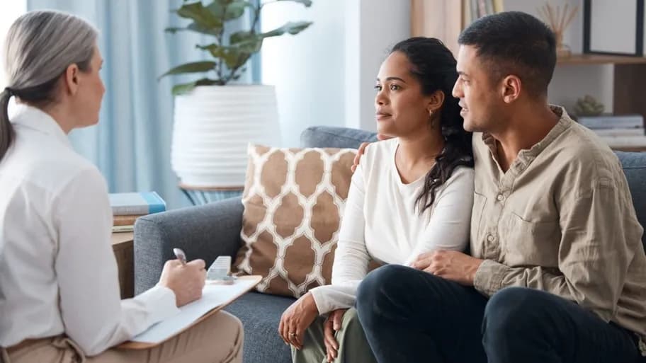 Couple consulting with a care navigator about IVF treatment plans.